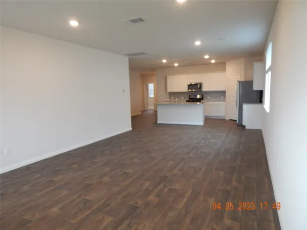 a view of kitchen with kitchen island microwave and stove