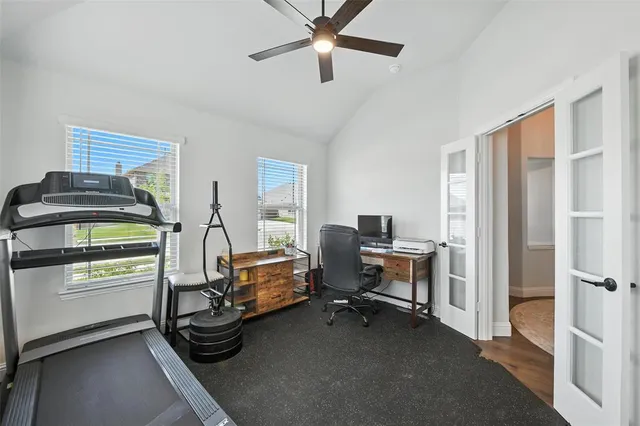 a view of a livingroom with workspace and a window