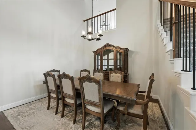a view of a dining room with furniture and a chandelier