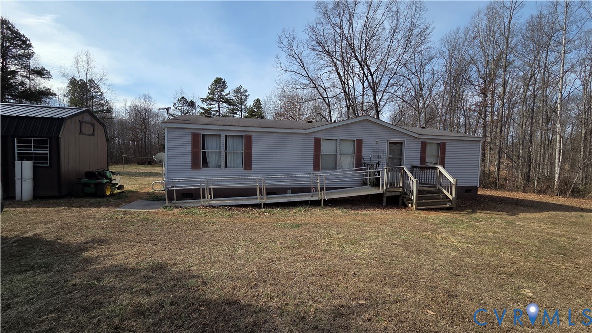 591 Byrd Mill Road Louisa, VA 23093 - Photo 1 of 13 a view of a house with a yard and a large tree