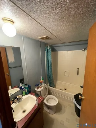 a bathroom with a sink mirror and toilet