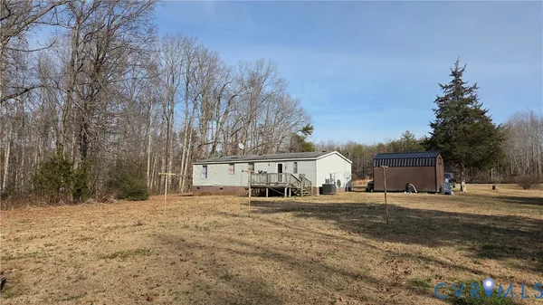 a row of house with large trees in front of it
