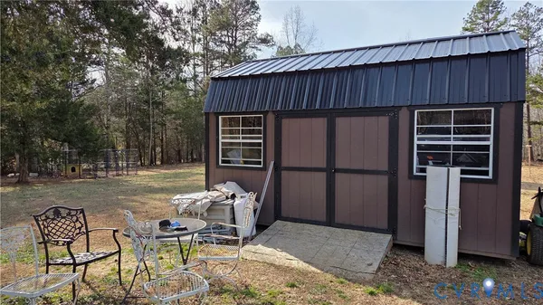 a backyard of a house with table and chairs