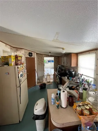 a kitchen with a refrigerator and a stove