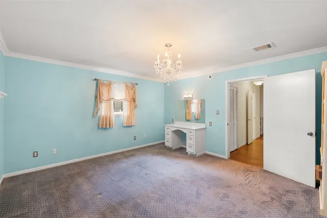 a room with table chairs and white walls