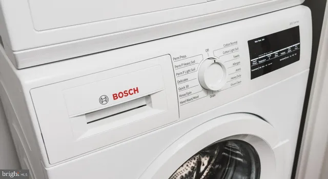a kitchen with granite countertop white cabinets and stainless steel appliances