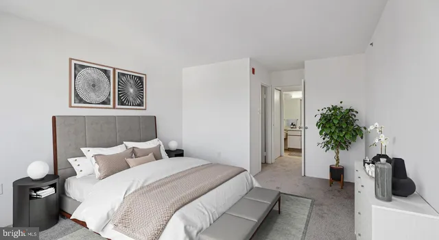 a bedroom with furniture and a potted plant