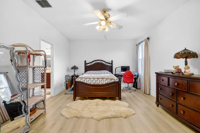 a living room with furniture and a dresser