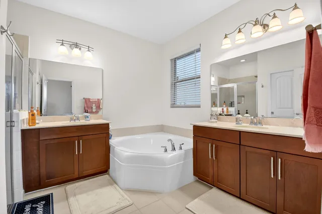 a bathroom with a tub sink and mirror