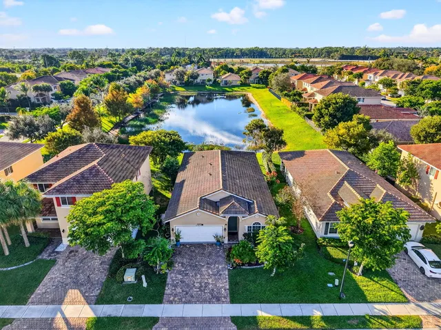 an aerial view of residential houses with outdoor space and swimming pool