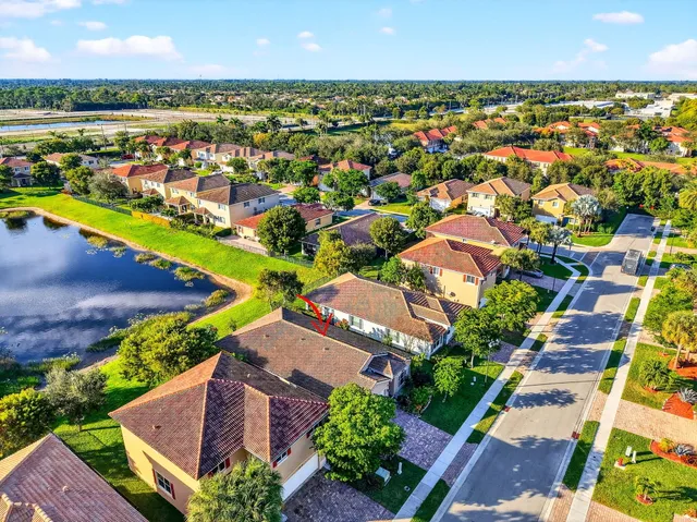 an aerial view of residential houses with outdoor space and river