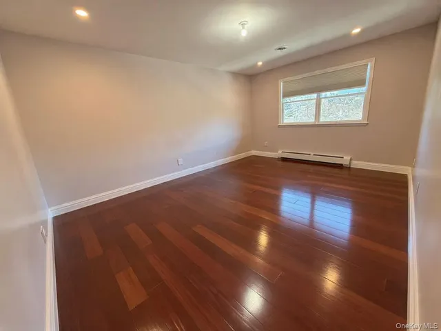 a bathroom with a granite countertop toilet sink and mirror