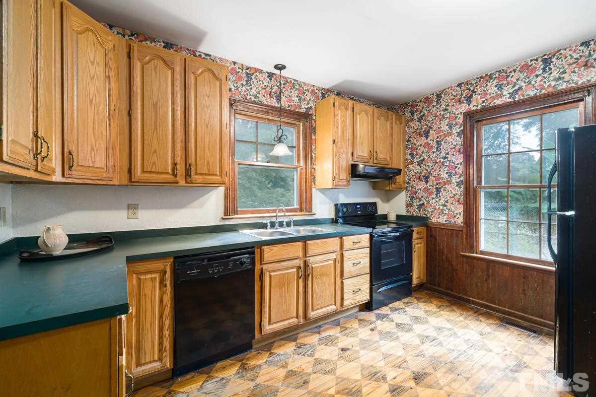 515 Polk Street Raleigh, NC 27604 - Photo 11 of 25 a kitchen with stainless steel appliances granite countertop a stove a sink and a microwave