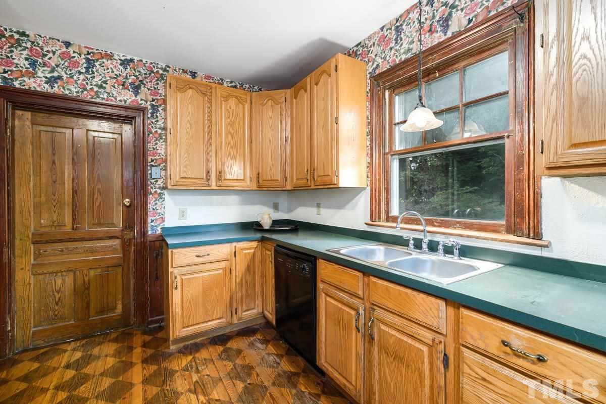 515 Polk Street Raleigh, NC 27604 - Photo 13 of 25 a kitchen with stainless steel appliances granite countertop a refrigerator and a sink