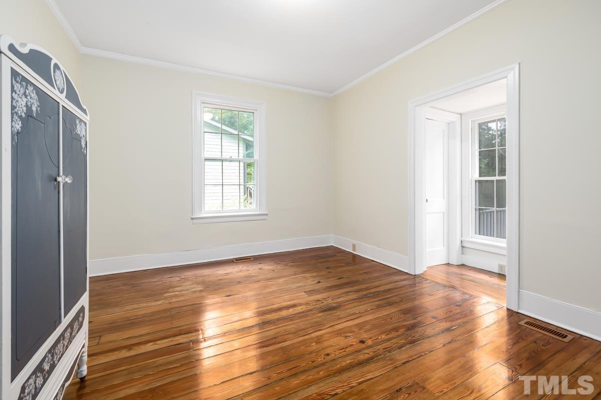 515 Polk Street Raleigh, NC 27604 - Photo 14 of 25 a view of an empty room with wooden floor and a window