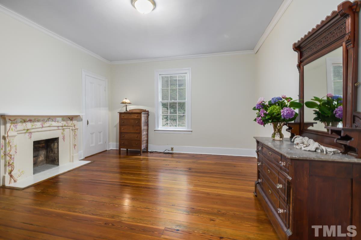 515 Polk Street Raleigh, NC 27604 - Photo 17 of 25 a view of an empty room with wooden floor and a fireplace