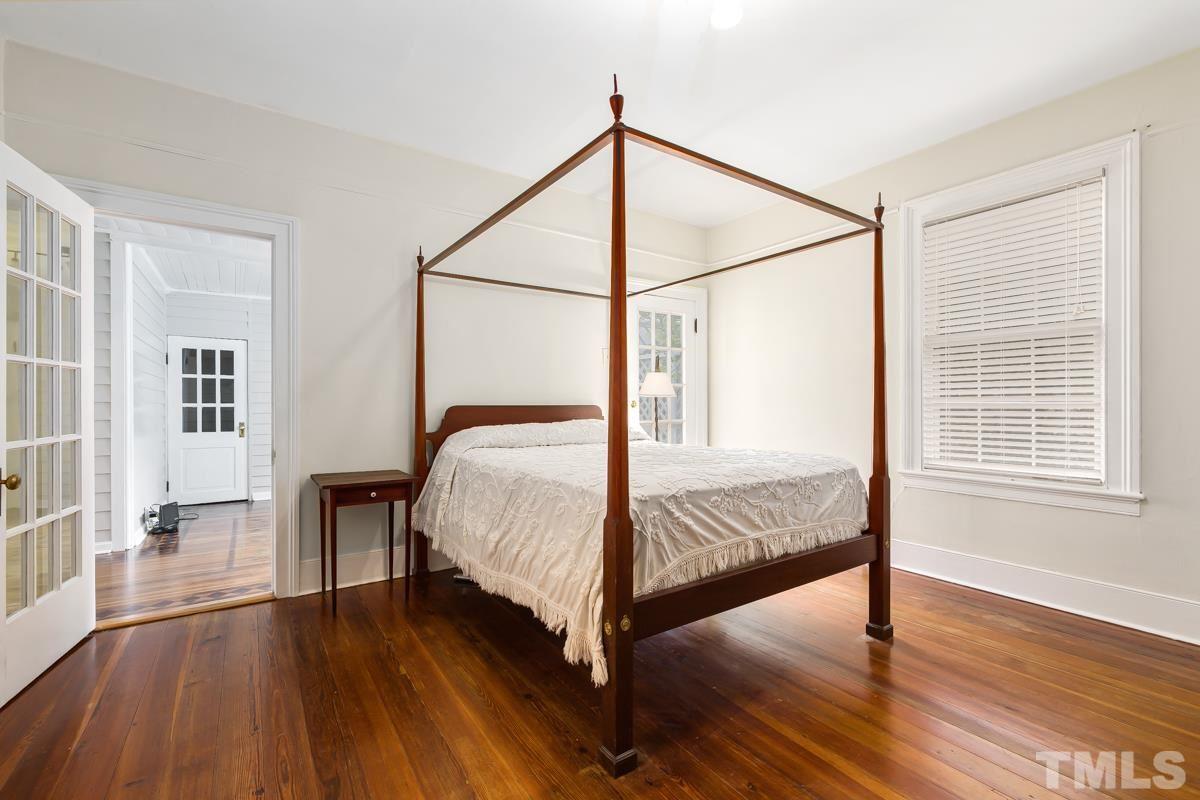 515 Polk Street Raleigh, NC 27604 - Photo 18 of 25 a bedroom with a bed and a table