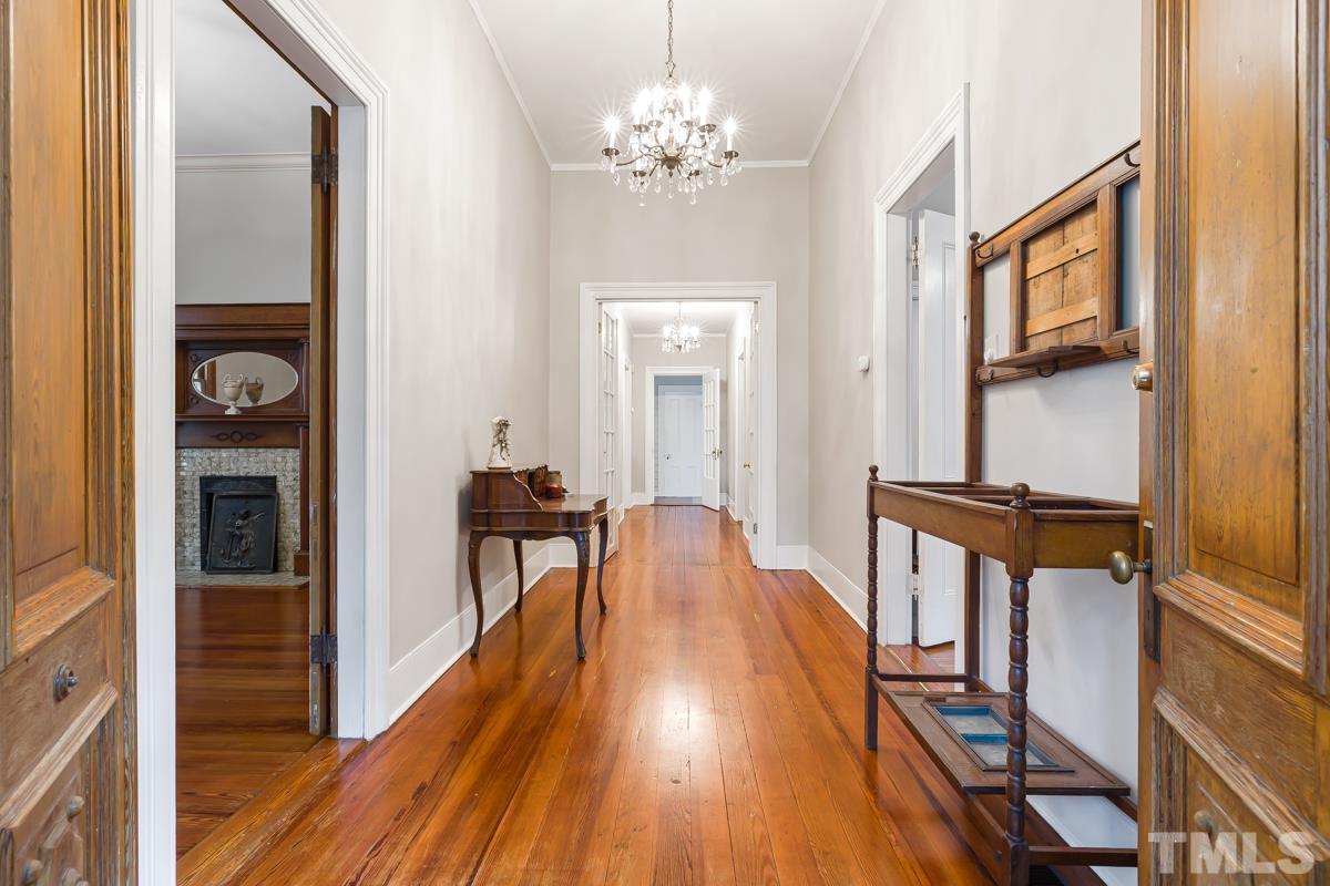 515 Polk Street Raleigh, NC 27604 - Photo 4 of 25 a view of a hallway with wooden floor and staircase