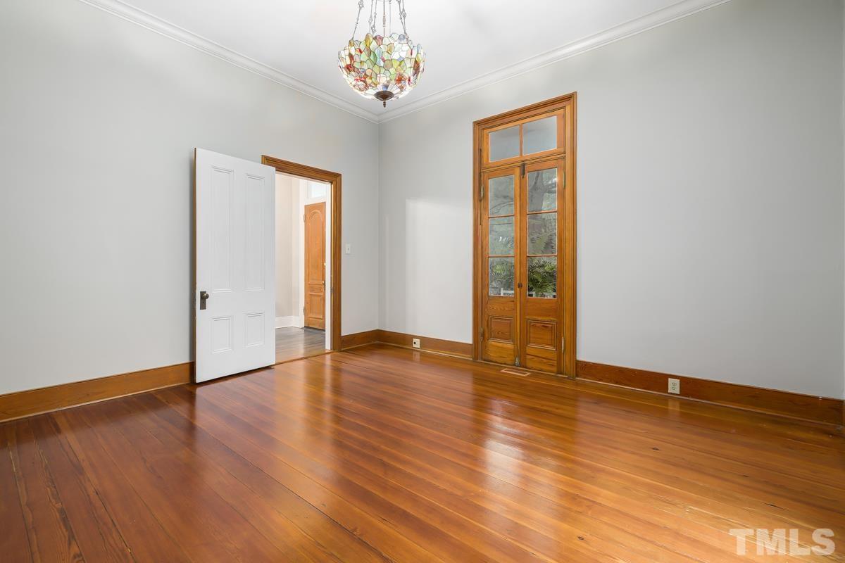 515 Polk Street Raleigh, NC 27604 - Photo 8 of 25 an empty room with wooden floor and windows