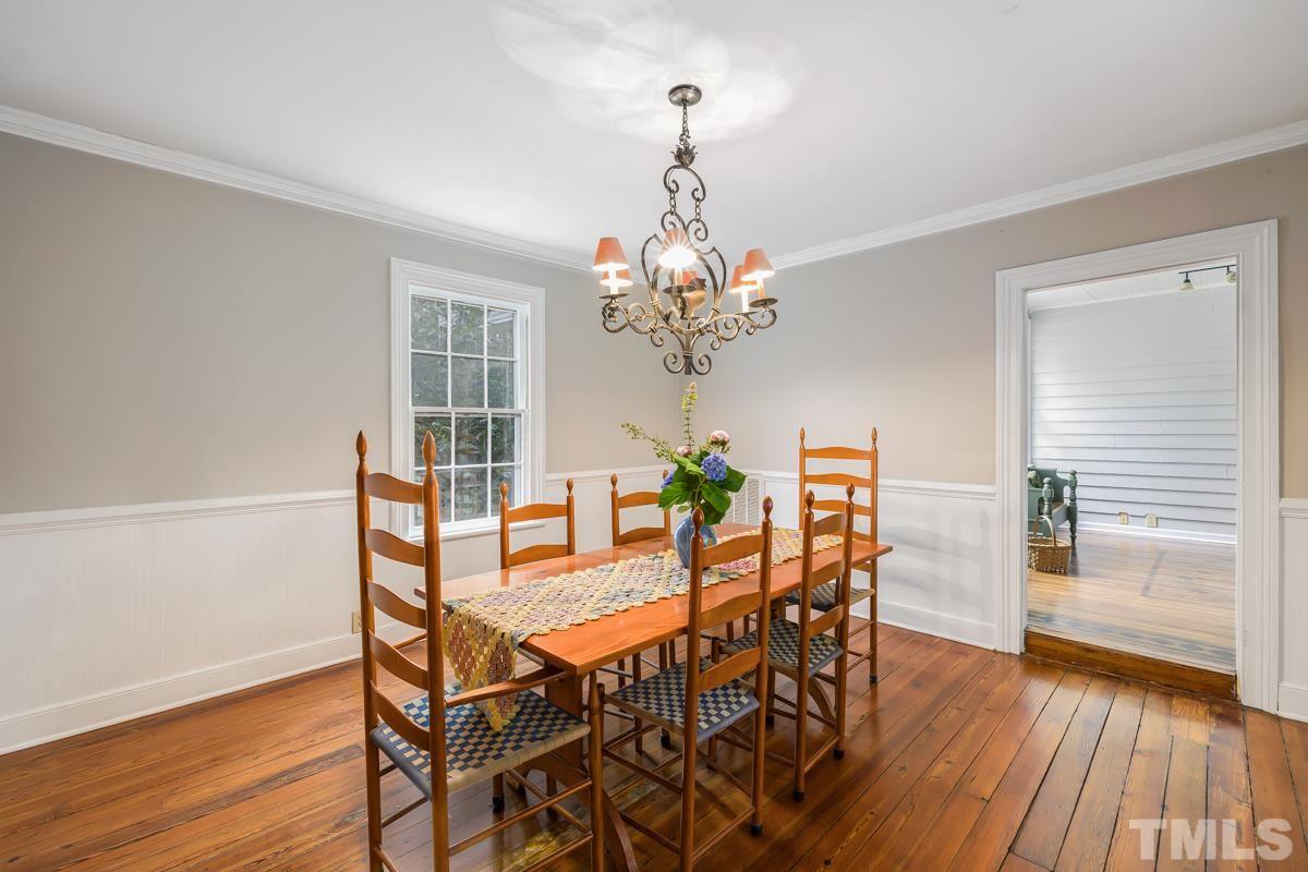 515 Polk Street Raleigh, NC 27604 - Photo 10 of 25 a view of a dining room with furniture wooden floor and chandelier