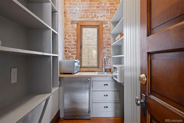 a kitchen with a refrigerator and window