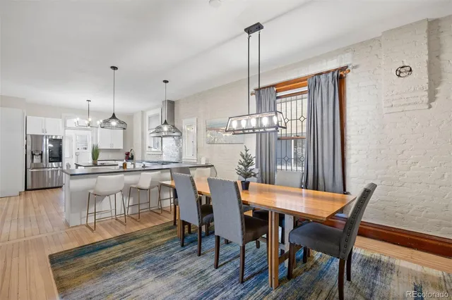 a dining room with furniture and wooden floor