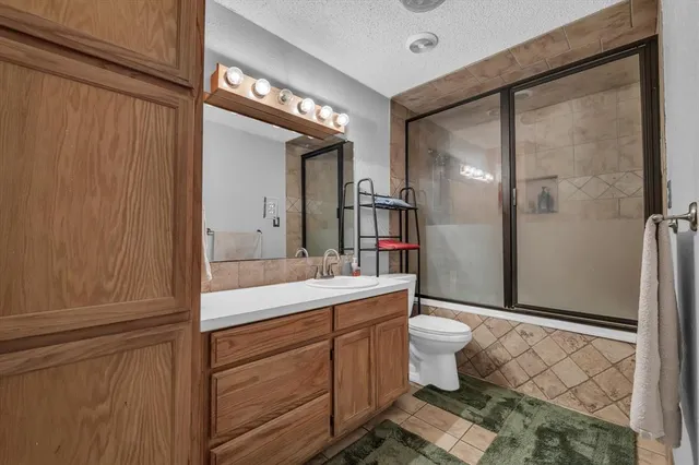 a spacious bedroom with a bed and a television