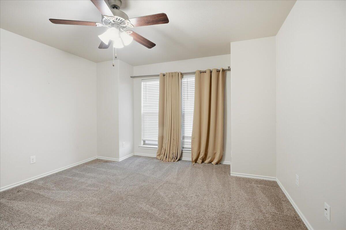 9819 Virginia Avenue Lubbock, TX 79424 - Photo 21 of 29 an empty room with chandelier fan