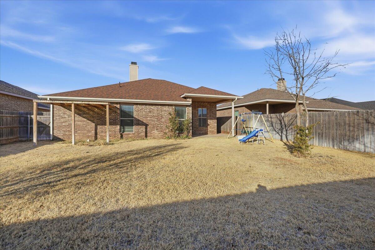 9819 Virginia Avenue Lubbock, TX 79424 - Photo 28 of 29 a front view of a house with a yard
