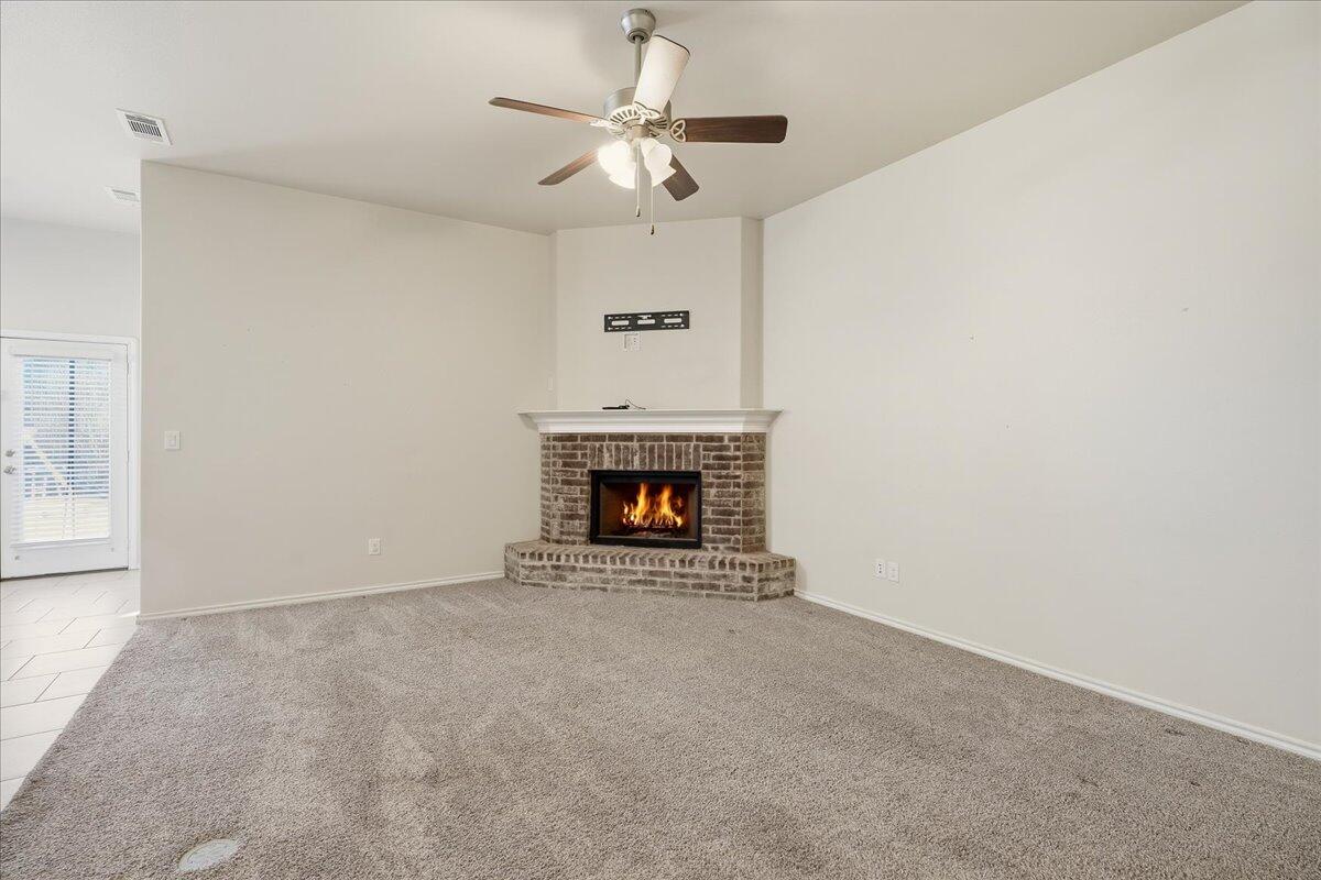 9819 Virginia Avenue Lubbock, TX 79424 - Photo 3 of 29 a view of an empty room with a fireplace