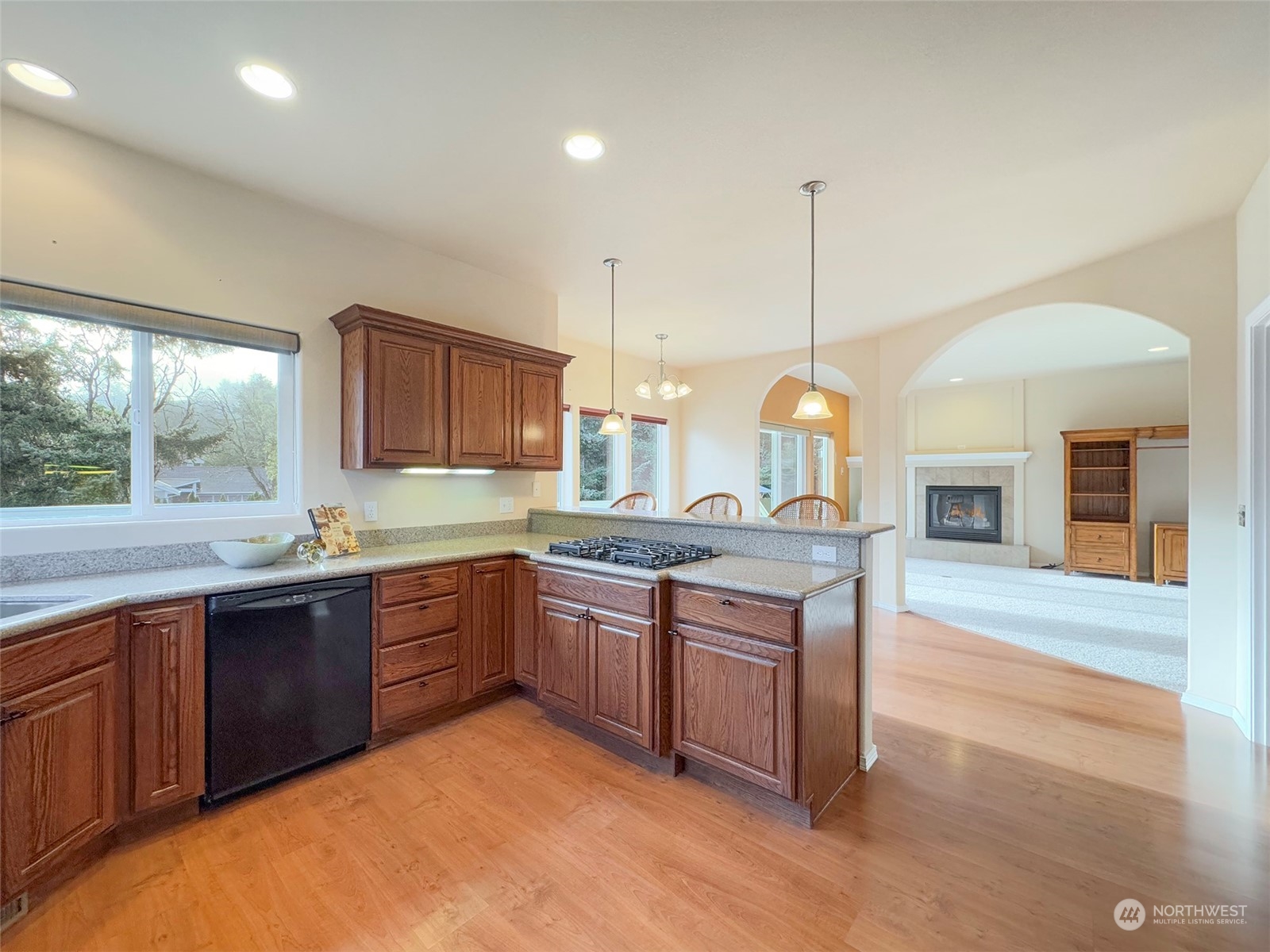 201 Brigadoon Boulevard Sequim, WA 98382 - Photo 12 of 35 a kitchen with stainless steel appliances granite countertop a stove a sink dishwasher and a wooden cabinets