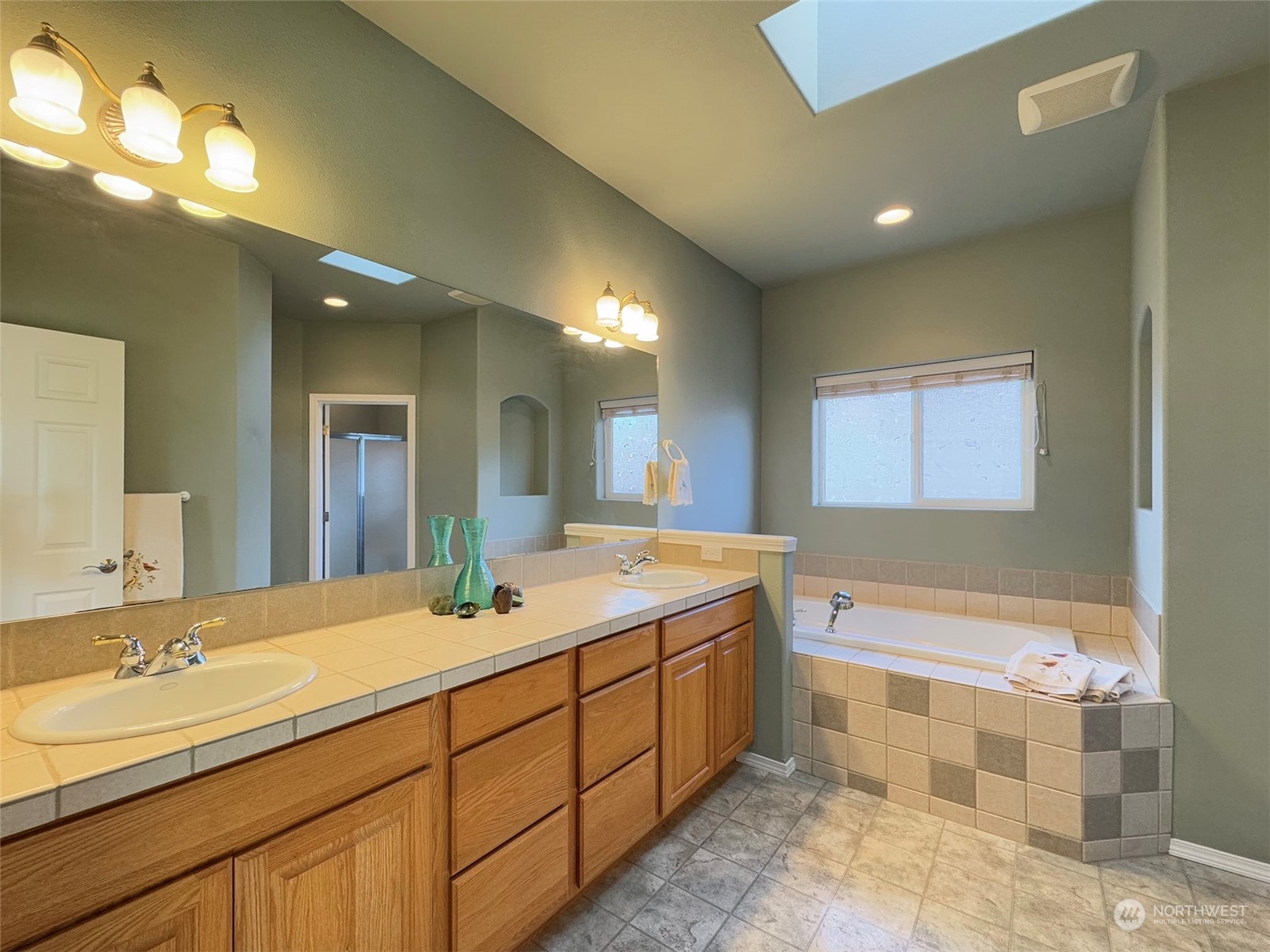 201 Brigadoon Boulevard Sequim, WA 98382 - Photo 23 of 35 a bathroom with a double vanity sink and a mirror