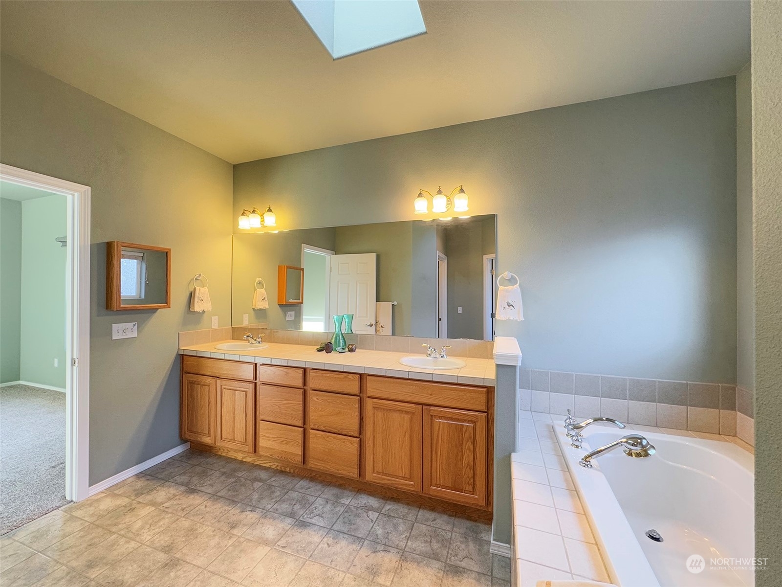 201 Brigadoon Boulevard Sequim, WA 98382 - Photo 24 of 35 a spacious bathroom with a tub sink and mirror