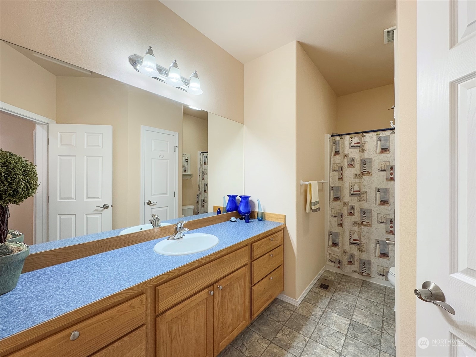 201 Brigadoon Boulevard Sequim, WA 98382 - Photo 29 of 35 a bathroom with a sink vanity granite and a mirror