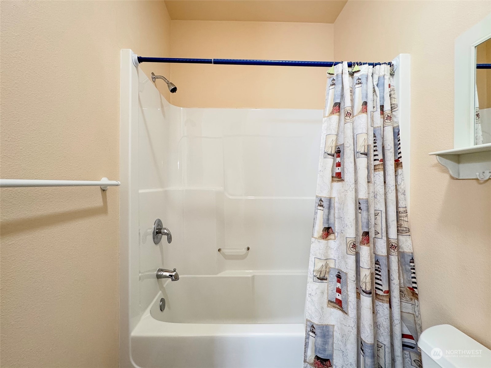 201 Brigadoon Boulevard Sequim, WA 98382 - Photo 30 of 35 a bathroom with a shower curtain and a toilet