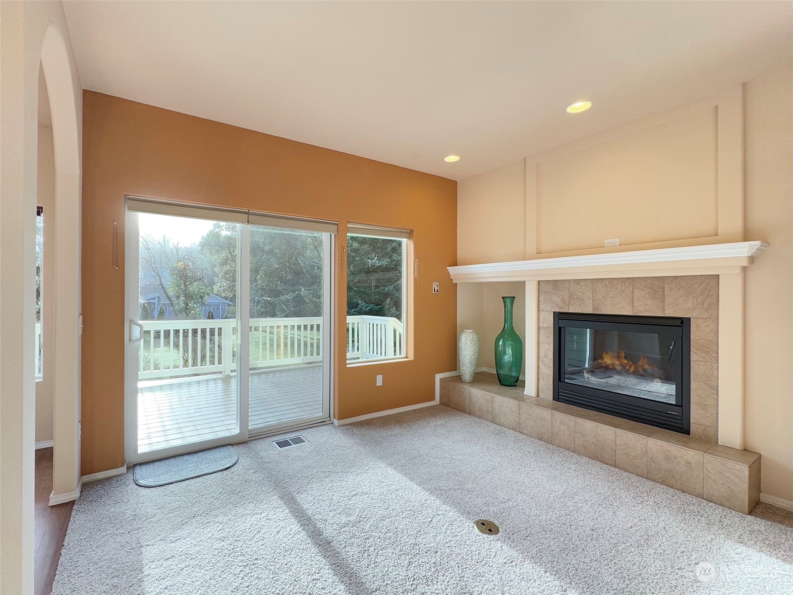 201 Brigadoon Boulevard Sequim, WA 98382 - Photo 7 of 35 a living room with a fireplace and a large window