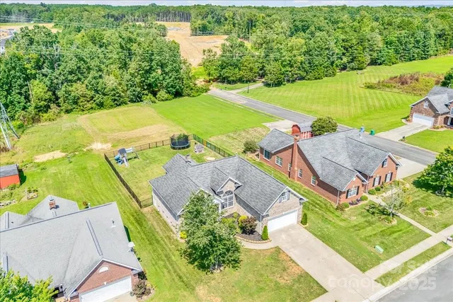 an aerial view of a house with a yard basket ball court and outdoor seating
