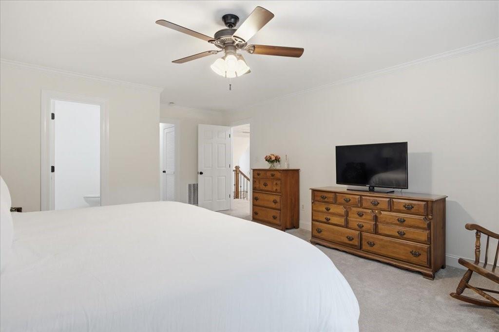 397 Thomas Road Dallas, GA 30132 - Photo 46 of 108 a bedroom with a bed and a flat tv screen on dresser