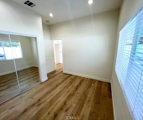 a view of an empty room and wooden floor