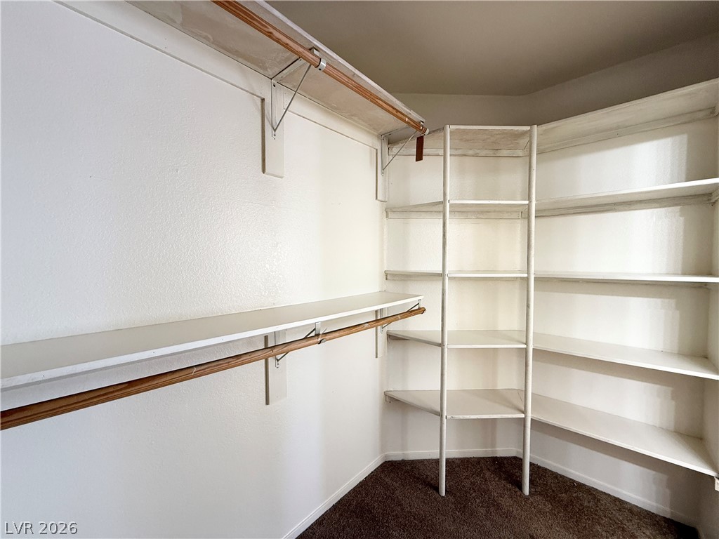 8870 Haviland Road Las Vegas, NV 89123 - Photo 14 of 24 Ample shelving and hanging space defines this practical, organized walk-in closet.