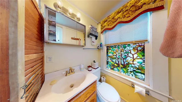a bathroom with a sink a toilet and a shower curtain