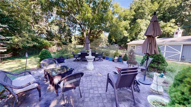 a view of a chairs and table in backyard of the house
