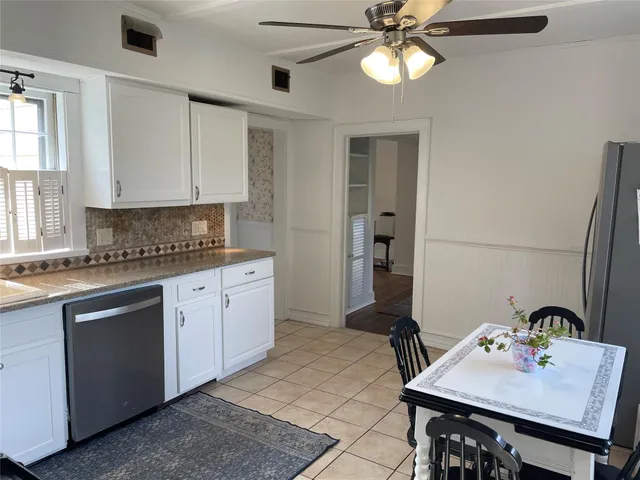 a kitchen with a sink cabinets and window