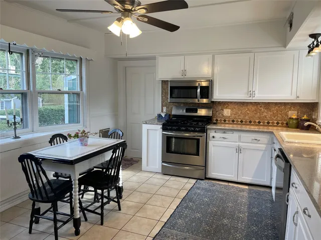 a kitchen with a stove a sink and a refrigerator