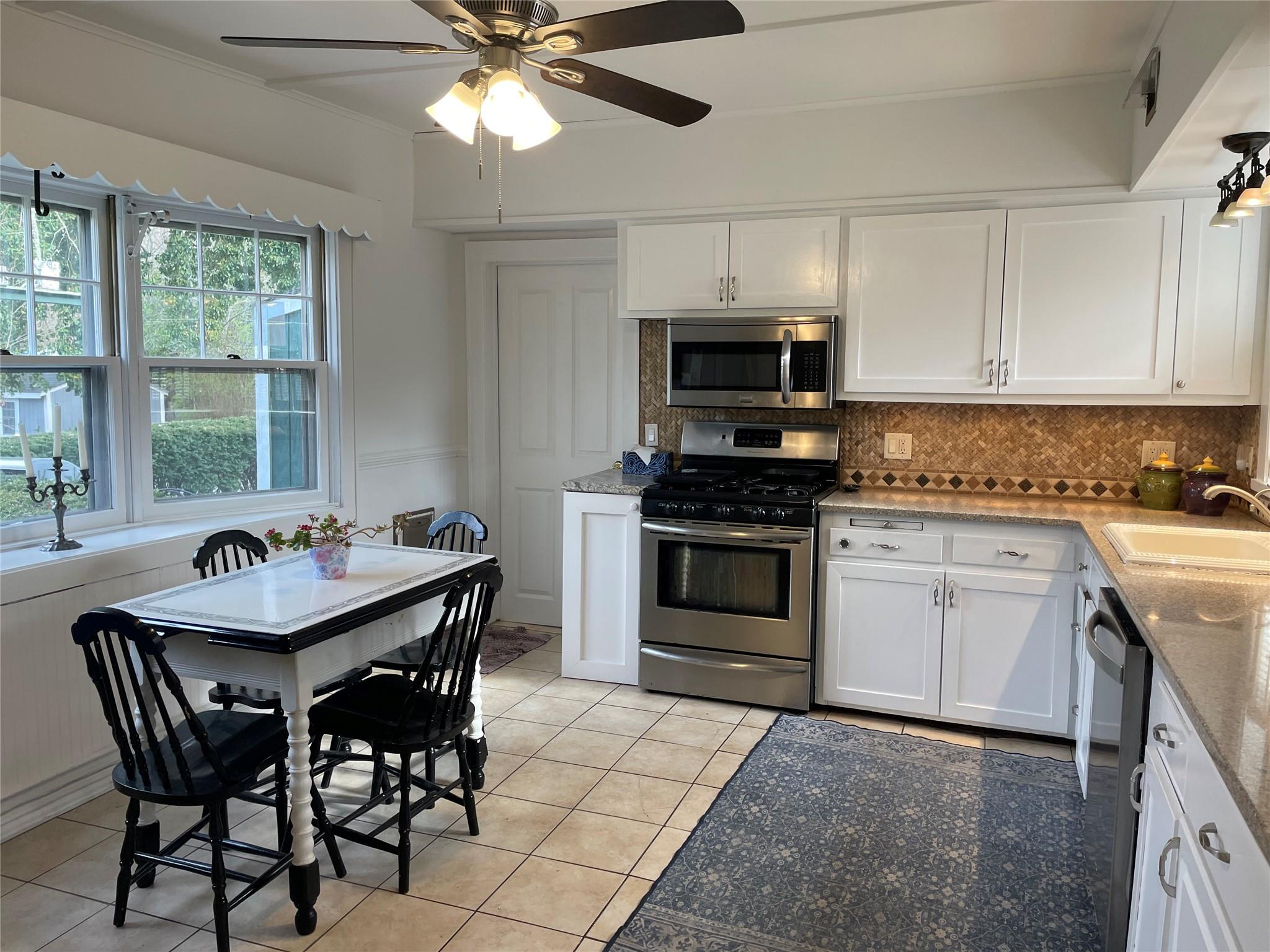 190 South Country Road Remsenburg, NY 11960 - Photo 6 of 20 a kitchen with a stove a sink and a refrigerator