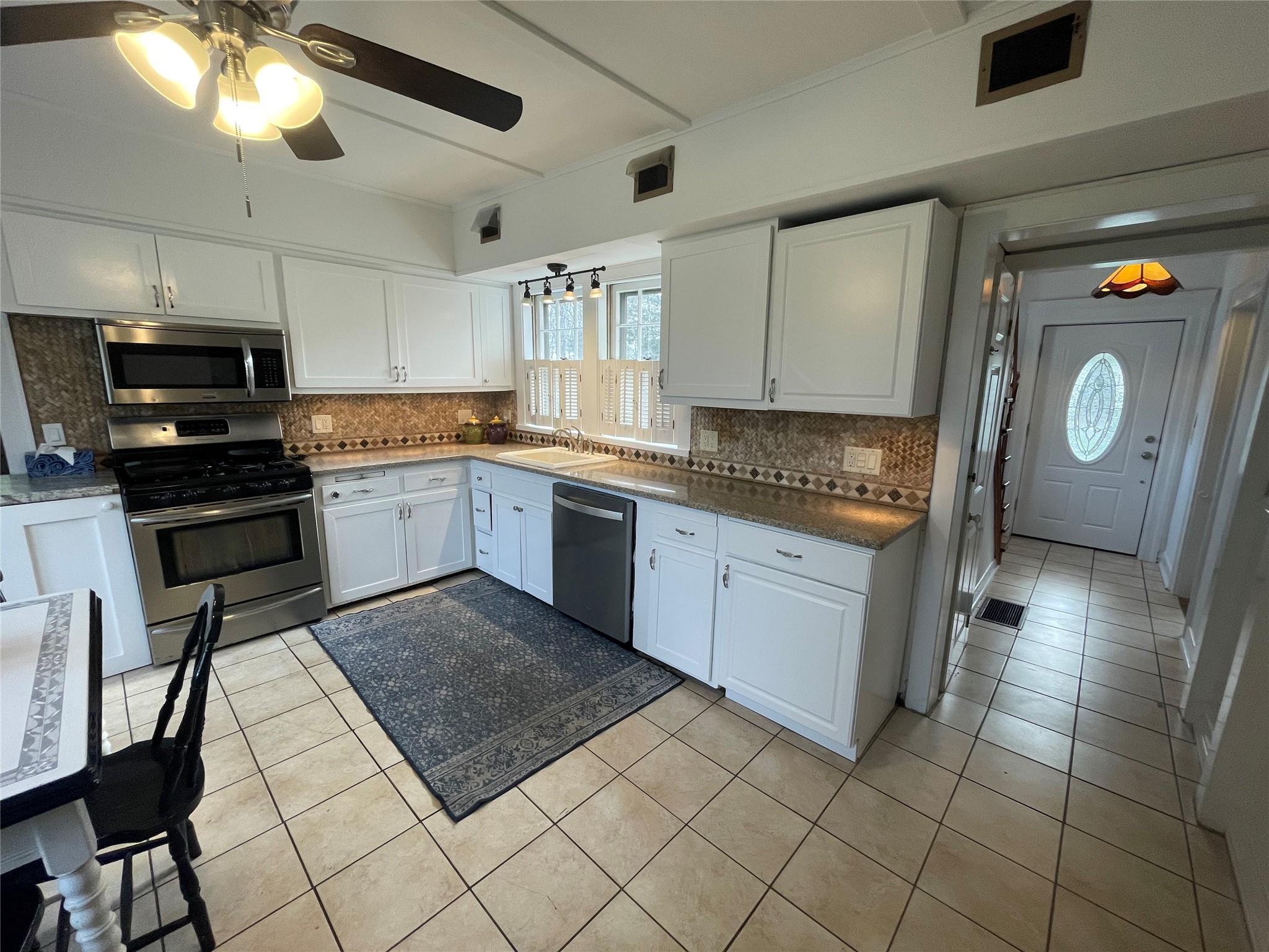 190 South Country Road Remsenburg, NY 11960 - Photo 7 of 20 a kitchen with a sink a stove and cabinets