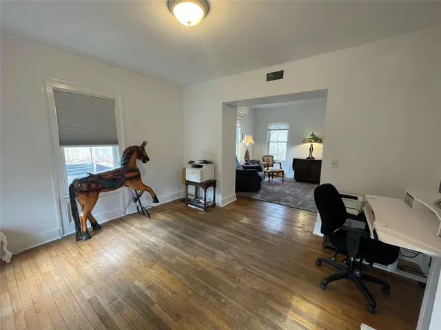 a view of a livingroom with furniture and a workspace