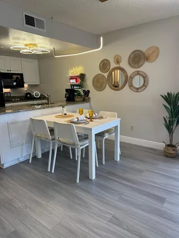 a dining room with furniture and wooden floor