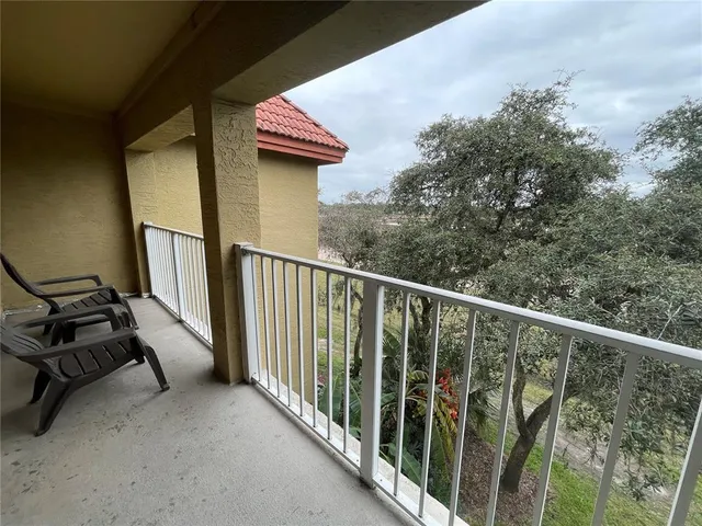 a view of a balcony with chairs