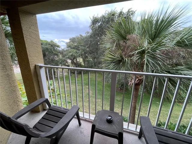 a view of a balcony with wooden floor